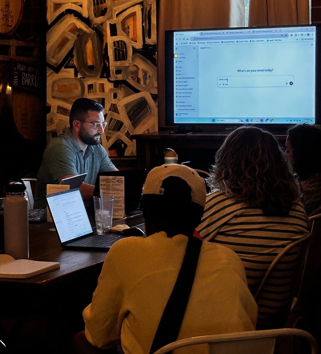 Hands-on ChatGPT workshop with a Clustr trainer and small group working on laptops