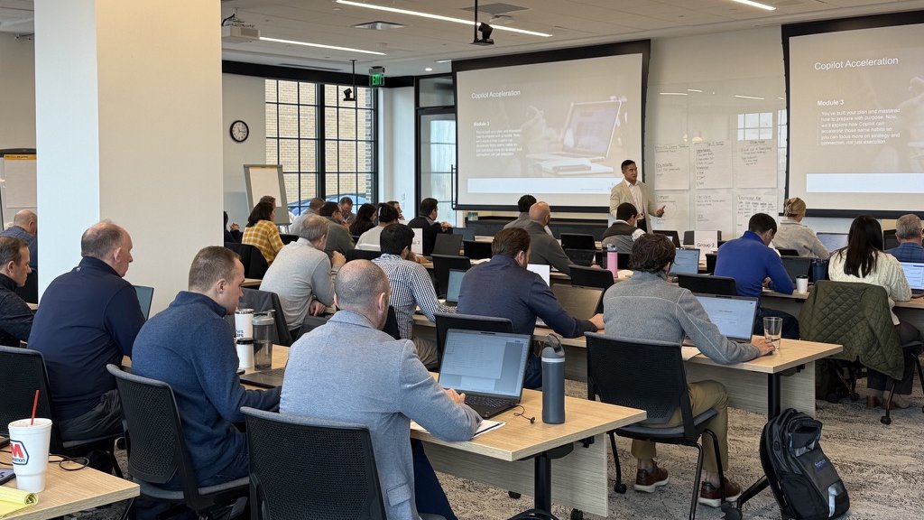 Full classroom of professionals in a Copilot acceleration training session