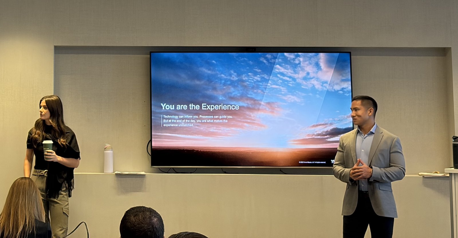 Two Clustr trainers presenting a leadership session titled You are the Experience